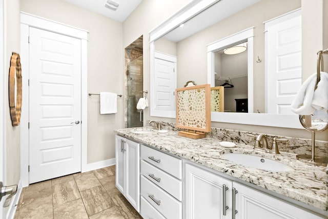 bathroom with vanity and a shower with shower door