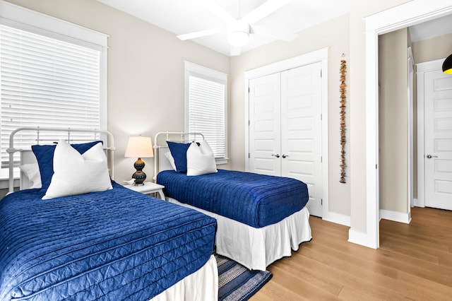 bedroom with a closet, ceiling fan, and hardwood / wood-style flooring