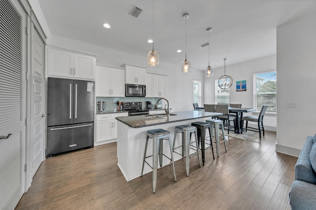 kitchen featuring white cabinetry, sink, an island with sink, and black appliances