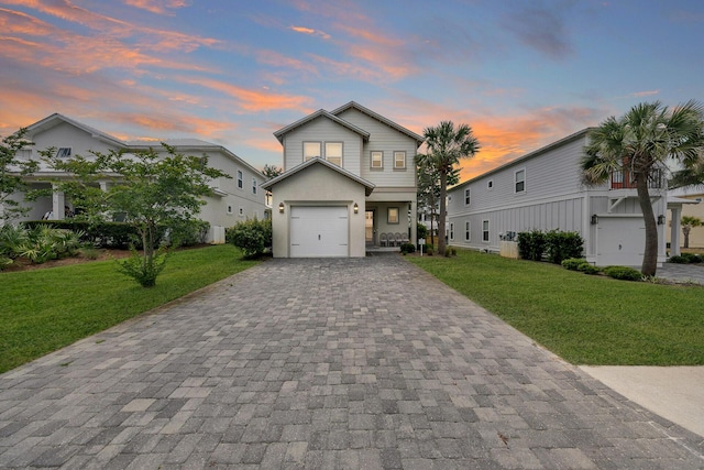 view of front facade featuring a garage and a lawn