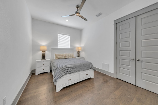 bedroom with a closet, ceiling fan, and dark wood-type flooring