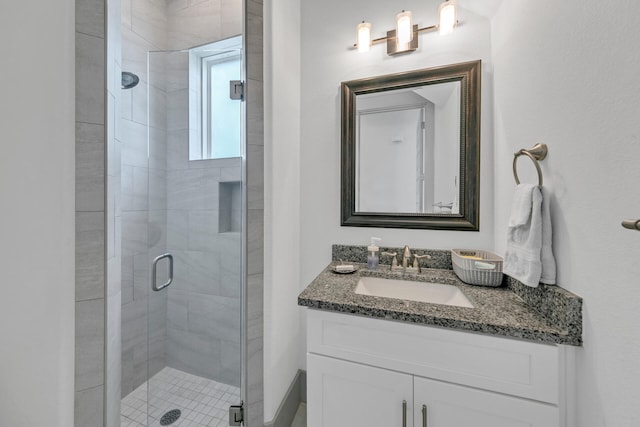 bathroom featuring vanity and a shower with shower door