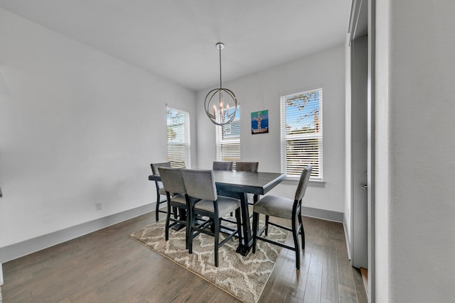 dining room featuring dark hardwood / wood-style floors, an inviting chandelier, and plenty of natural light