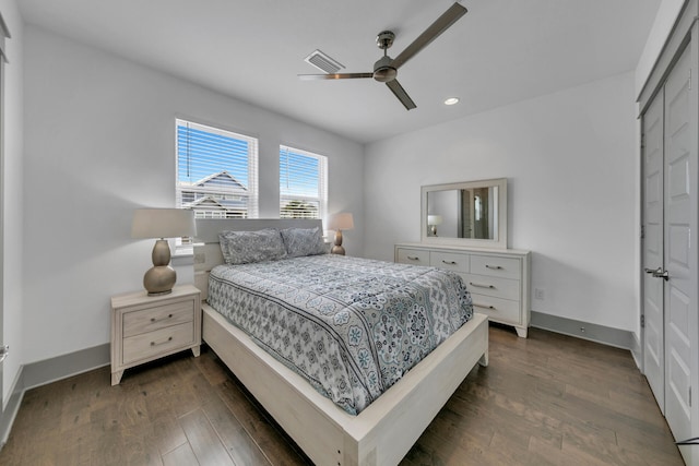 bedroom featuring ceiling fan, a closet, and dark hardwood / wood-style floors