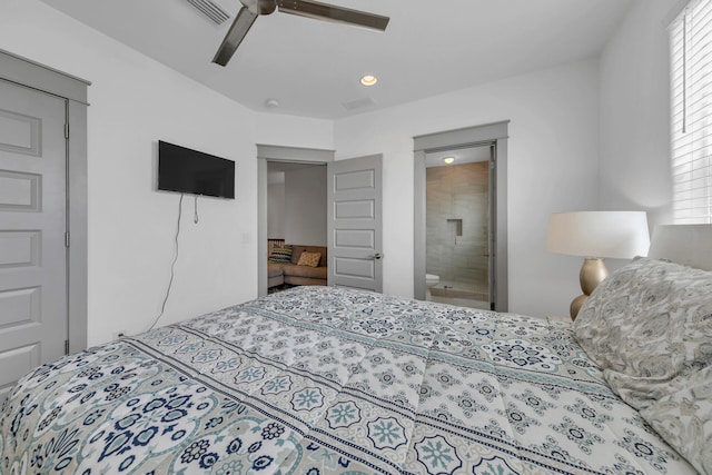 bedroom featuring ceiling fan, connected bathroom, and multiple windows