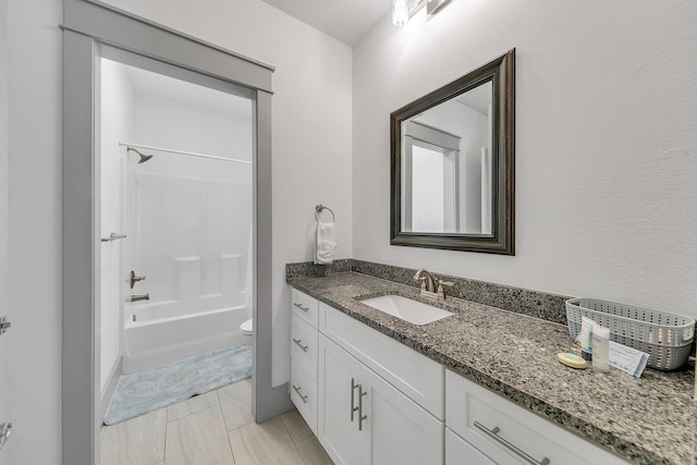 full bathroom featuring toilet, vanity, tile patterned floors, and tub / shower combination