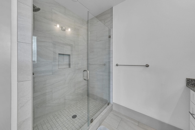 bathroom featuring tile patterned floors, vanity, and walk in shower