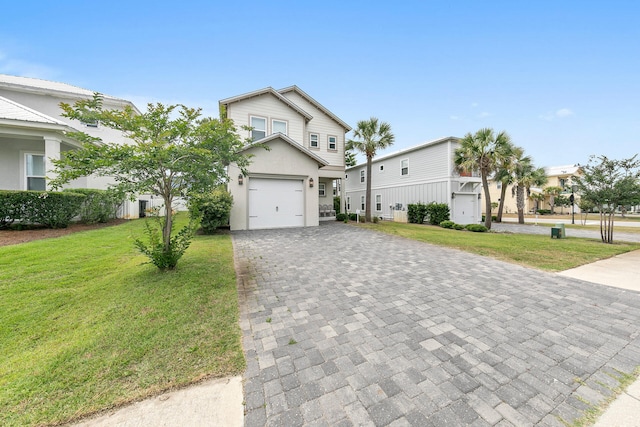 view of front of home featuring a garage and a front lawn