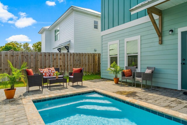 view of swimming pool with outdoor lounge area and a patio