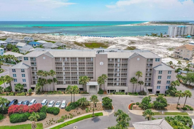 drone / aerial view featuring a beach view and a water view