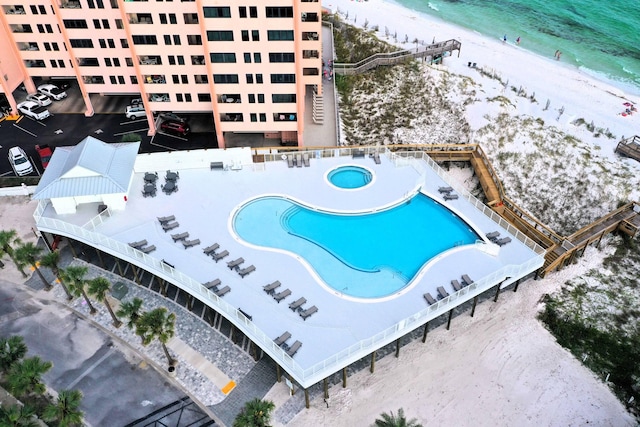 birds eye view of property with a beach view and a water view