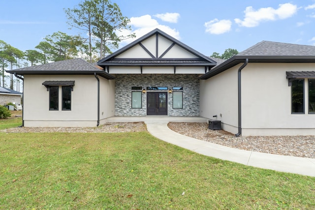 back of house with a lawn