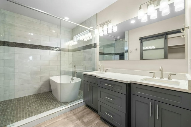 bathroom featuring independent shower and bath, vanity, and hardwood / wood-style flooring