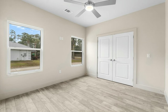 unfurnished bedroom with a closet, ceiling fan, and light wood-type flooring