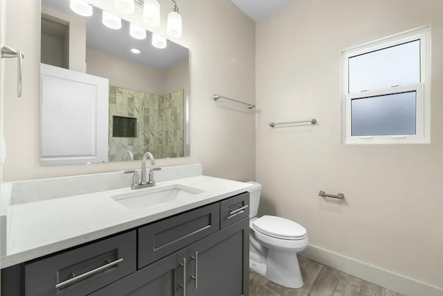 bathroom featuring toilet, wood-type flooring, and vanity