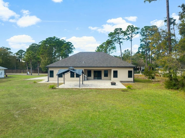 back of property featuring a lawn and a patio area