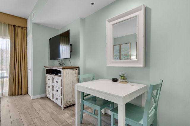 dining space with light hardwood / wood-style flooring