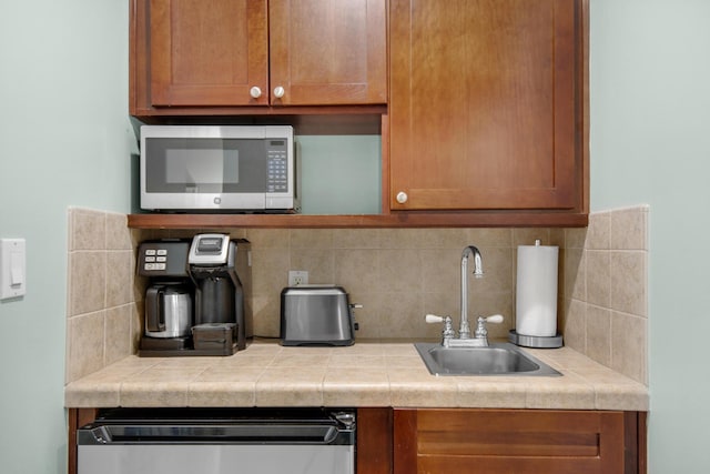 kitchen featuring tile counters, sink, and tasteful backsplash