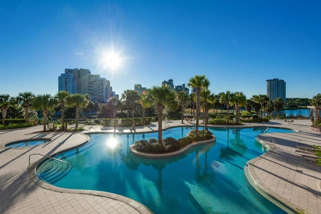 view of swimming pool with a community hot tub and a patio area