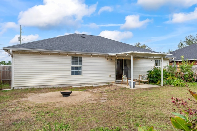 rear view of property featuring a patio and a yard