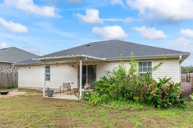 back of property with a patio area and a yard