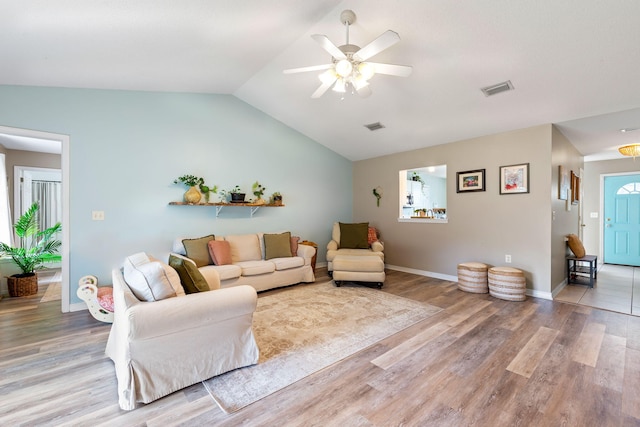 living room featuring ceiling fan, hardwood / wood-style floors, and lofted ceiling