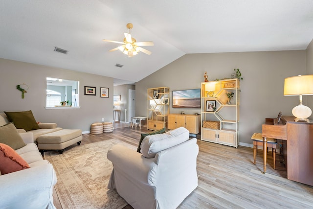 living room with ceiling fan, vaulted ceiling, and light hardwood / wood-style floors