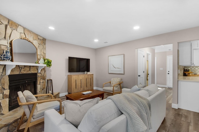 living room with hardwood / wood-style flooring and a fireplace