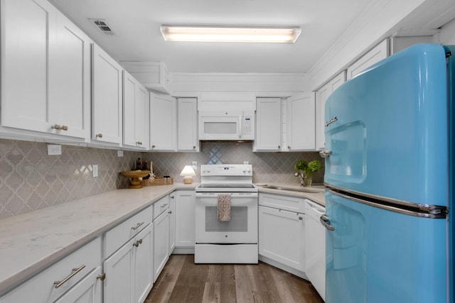 kitchen with white cabinetry, sink, dark wood-type flooring, and white appliances