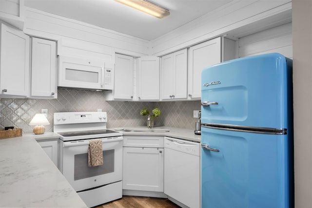 kitchen featuring white cabinetry, sink, white appliances, and decorative backsplash