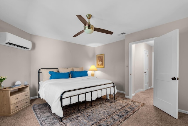 carpeted bedroom with a wall unit AC and ceiling fan