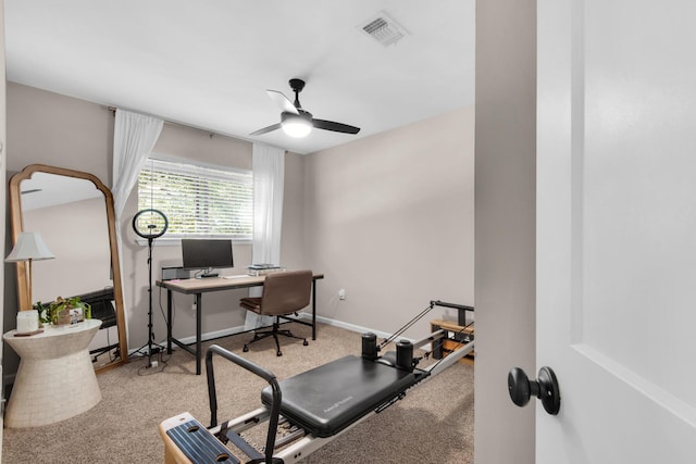 carpeted office space with ceiling fan