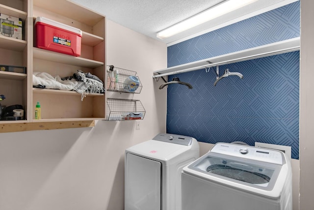 laundry room featuring separate washer and dryer and a textured ceiling