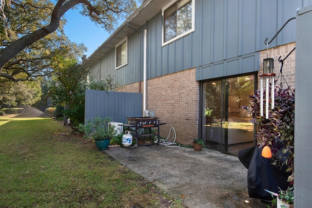 view of home's exterior with a yard and a patio area