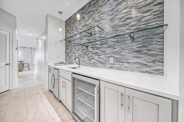 kitchen with white cabinetry, sink, wine cooler, refrigerator, and decorative light fixtures