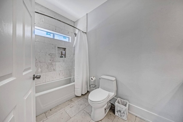 bathroom with tile patterned floors, shower / bath combo, and toilet