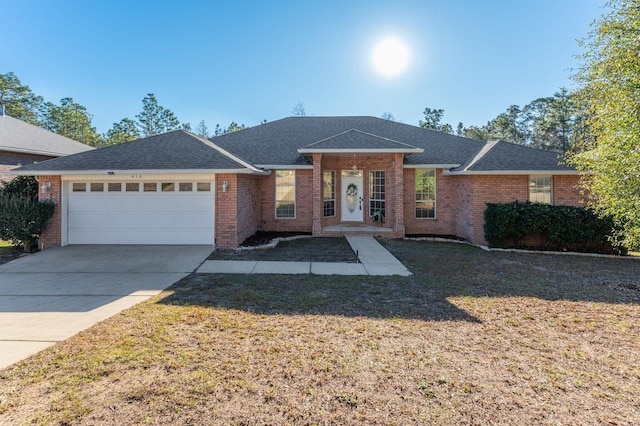 ranch-style home featuring a front lawn and a garage