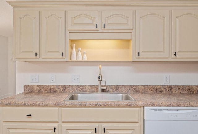 kitchen with dishwasher, cream cabinets, and sink