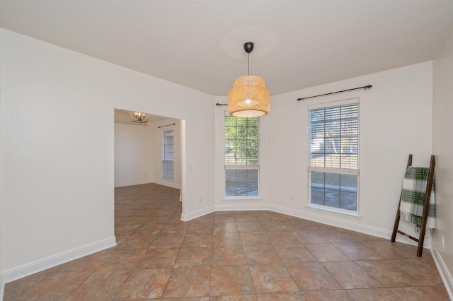 unfurnished dining area with a textured ceiling