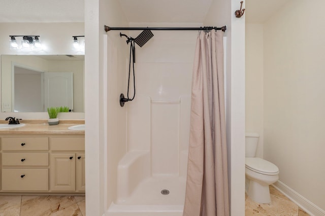 bathroom featuring vanity, toilet, and walk in shower