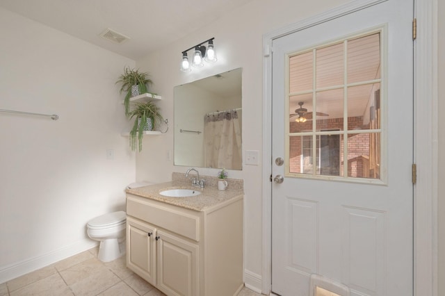 bathroom with vanity, ceiling fan, toilet, tile patterned floors, and a shower with shower curtain