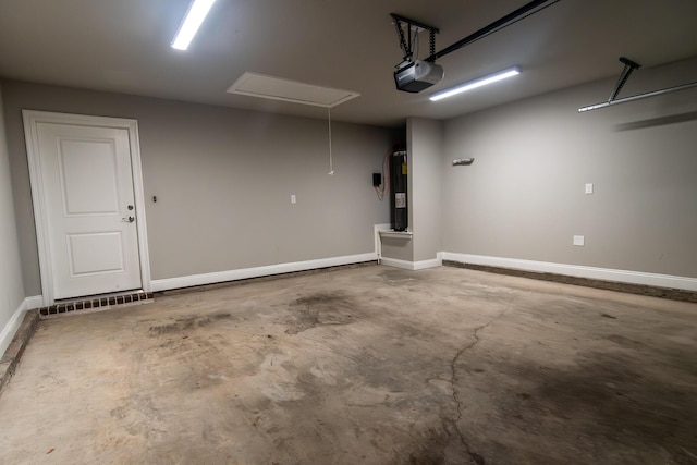 garage with a garage door opener and electric water heater