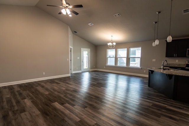 unfurnished living room featuring ceiling fan with notable chandelier, high vaulted ceiling, dark hardwood / wood-style flooring, and sink