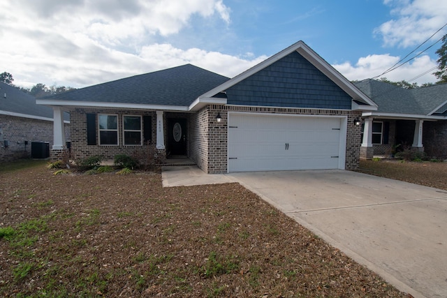 craftsman-style house with a garage and cooling unit