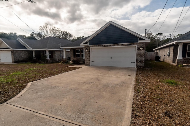 view of front of property featuring a garage and central AC unit