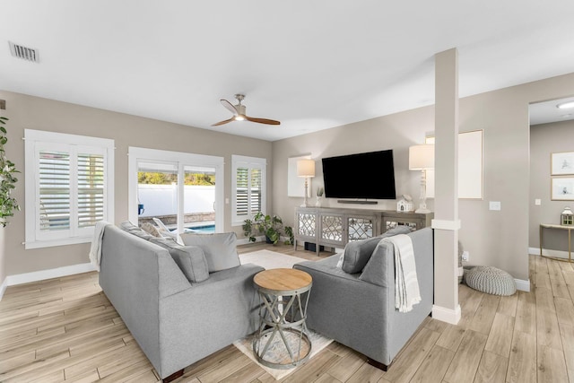 living room with ceiling fan and light hardwood / wood-style flooring