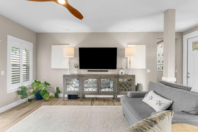 living room with light hardwood / wood-style floors and ceiling fan