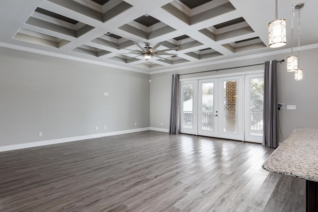 unfurnished living room with ceiling fan, dark wood-type flooring, coffered ceiling, and crown molding