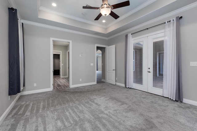 unfurnished bedroom featuring a raised ceiling, light colored carpet, ceiling fan, french doors, and access to exterior