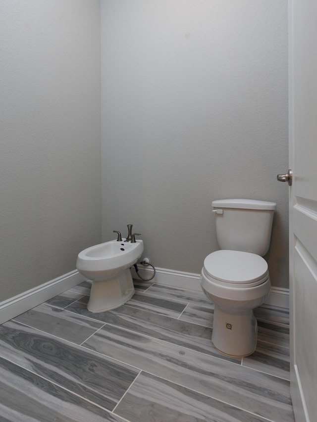 bathroom featuring toilet and a bidet